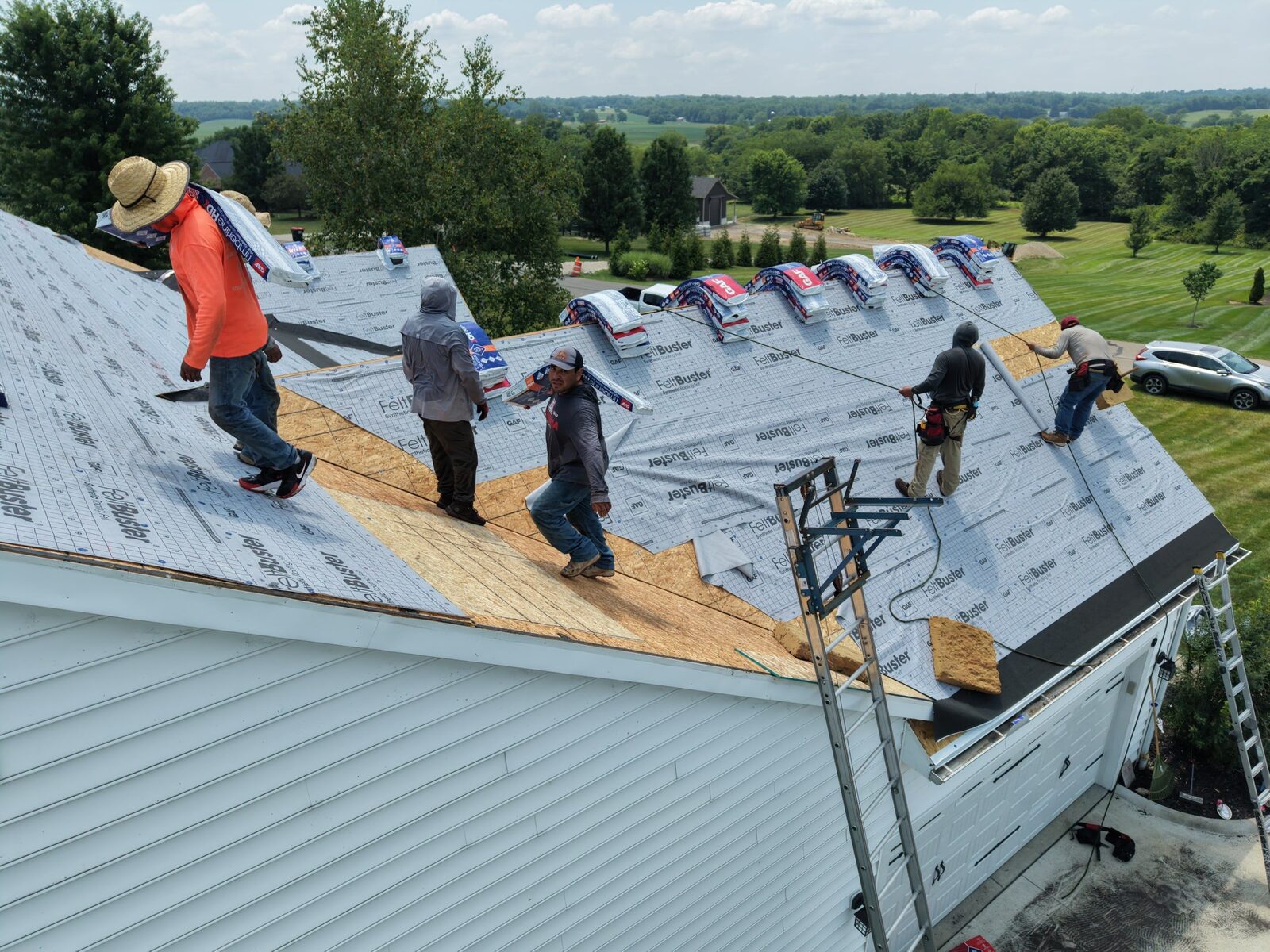 The crew laying new architectural shingles