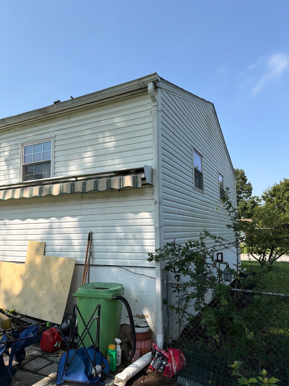 The original gutter and downspout on the side elevation before removal