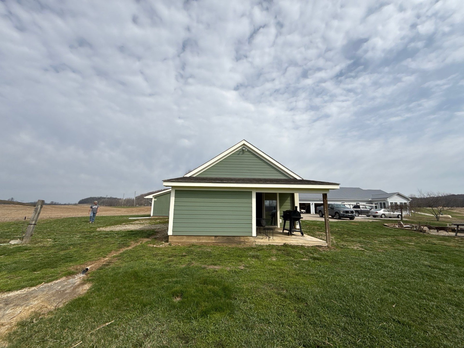 The outbuilding before the project, its wind-worn three-tab shingles near the end of their life