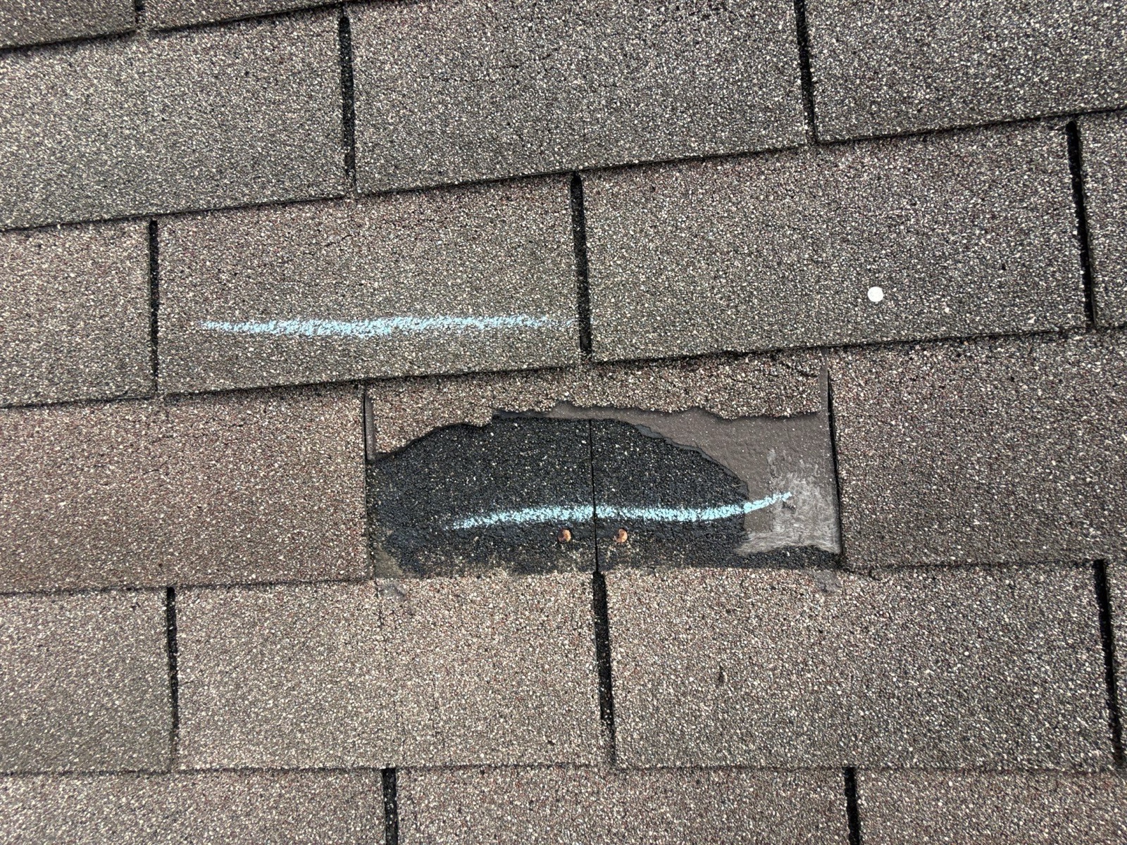 Shingles torn away by the wind, leaving the roof exposed