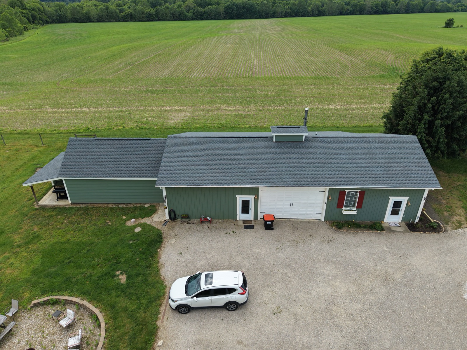 The finished roof and outbuilding from the drive